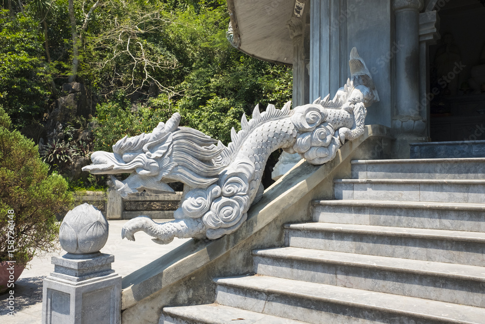 Architectural patterns of dragon carvings and flowers on stone in temple in Danang Vietnam