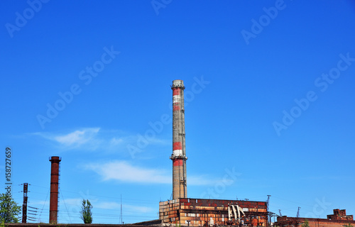 Brick pipe factory against a clear sky