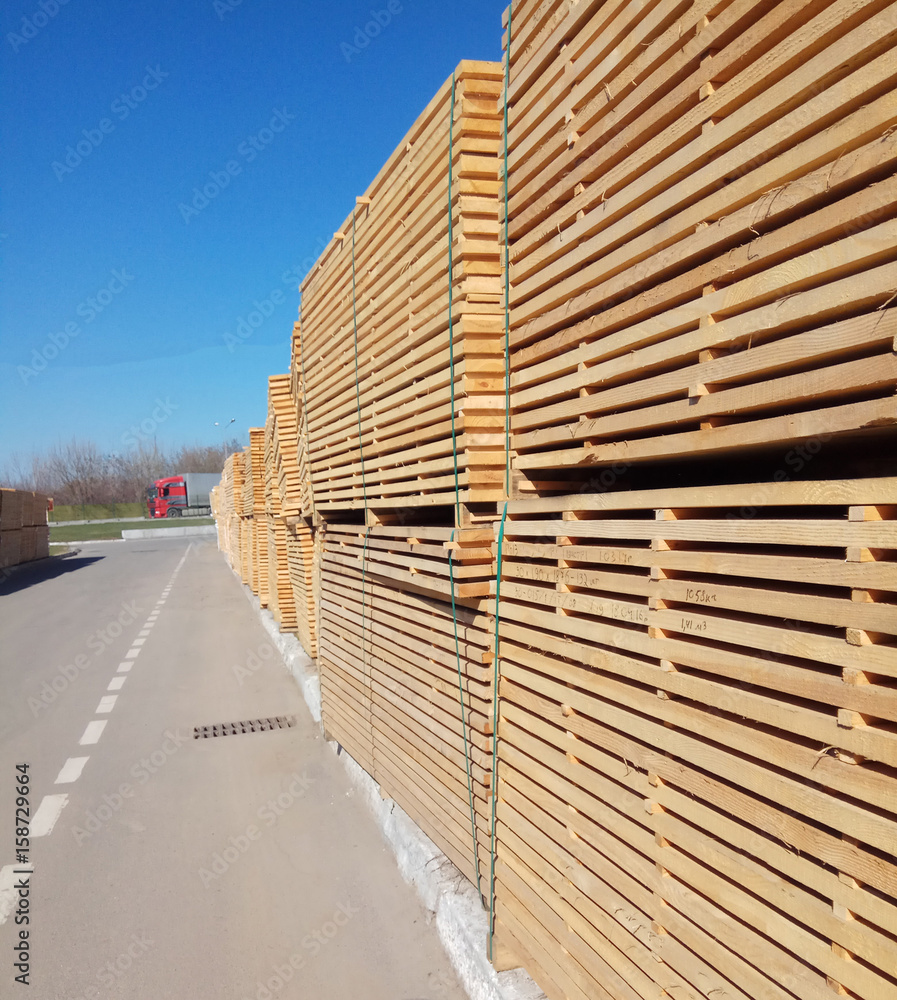Fototapeta premium stack of wooden planks at the lumber yard