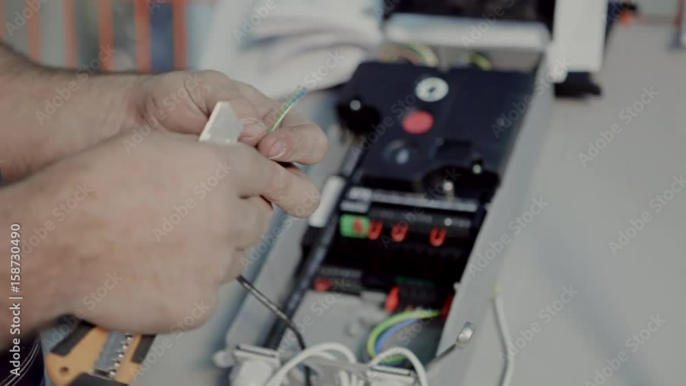 Engineer connects a wire to the machine Engineer connects a wire to the machine