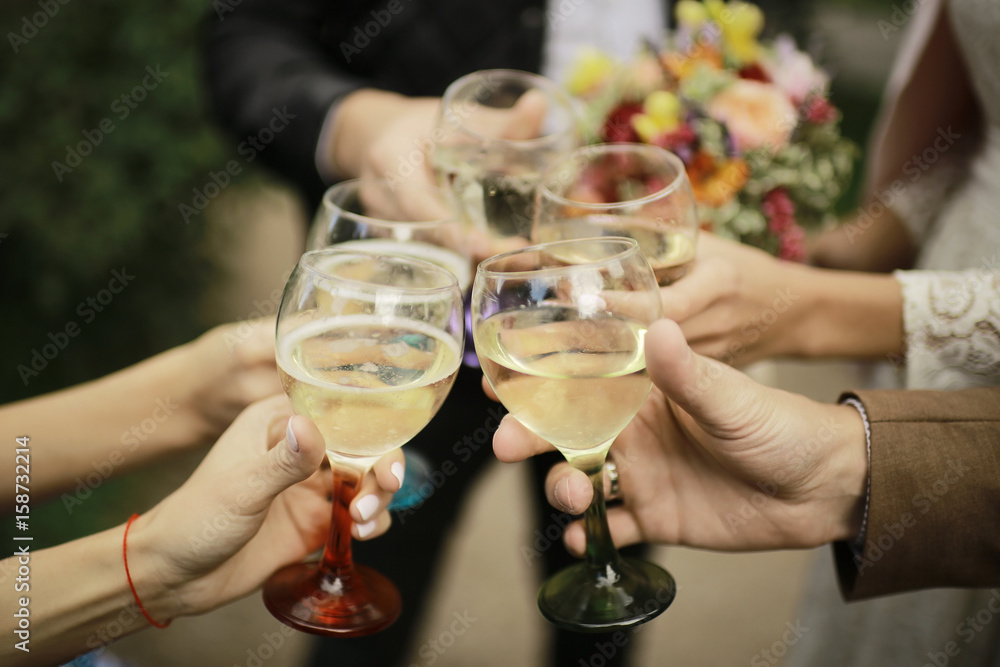 Glasses of the hand celebrating alcoholic clinking glasses Glasses of the hand celebrating alcoholic clinking glasses
