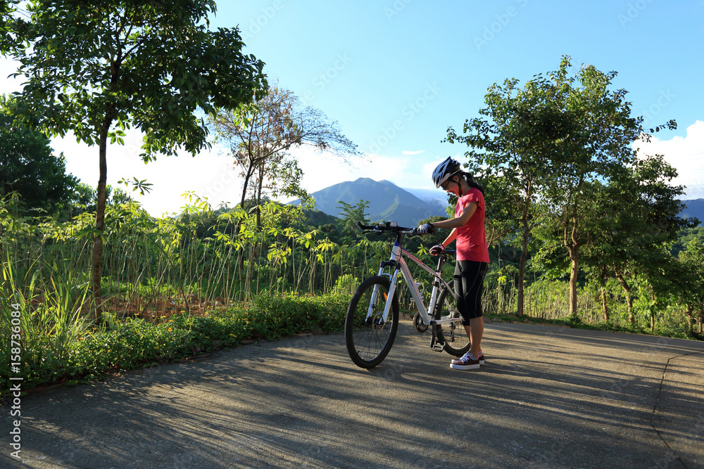 riding mountain bike on sunrise forest trail