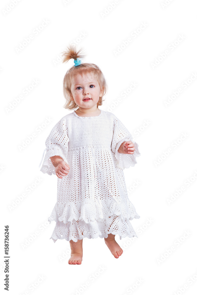Cute small baby girl in hand made lace dress walking towards camera Cute small baby girl in hand made lace dress walking towards camera