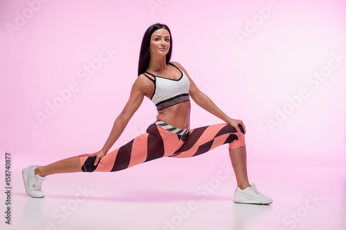 The woman training against pink studio