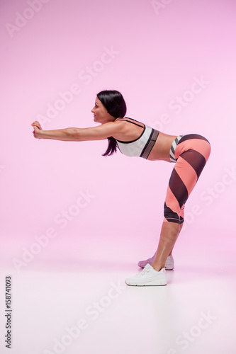 The woman training against pink studio