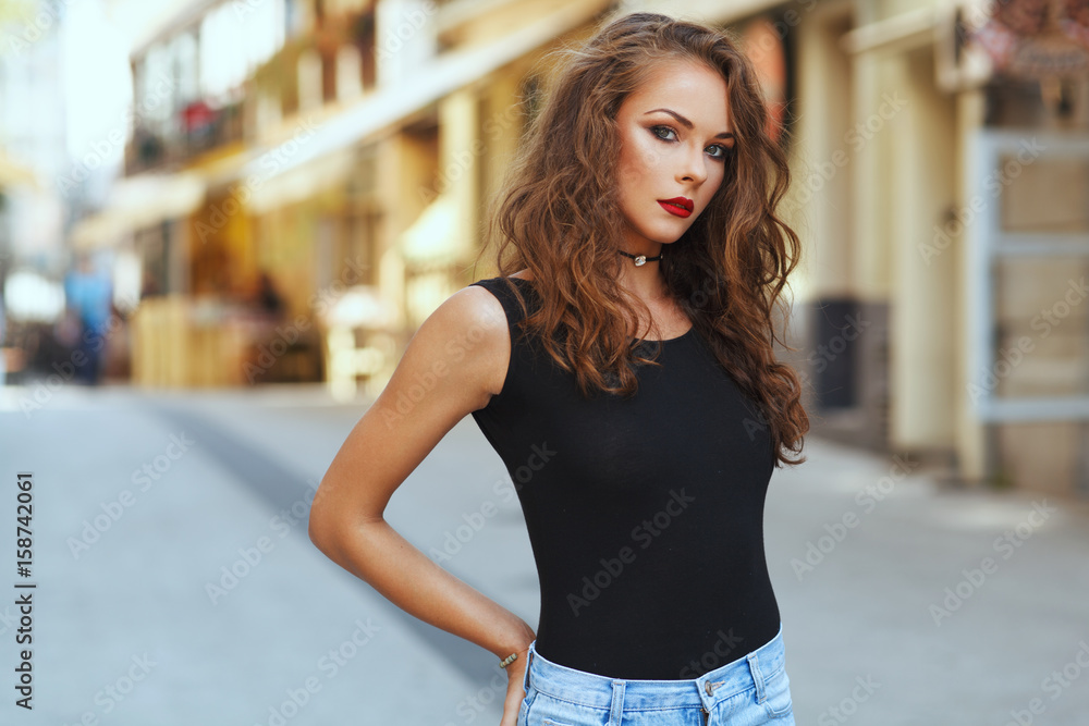 Potrait of beautiful young woman with beautiful curly hair