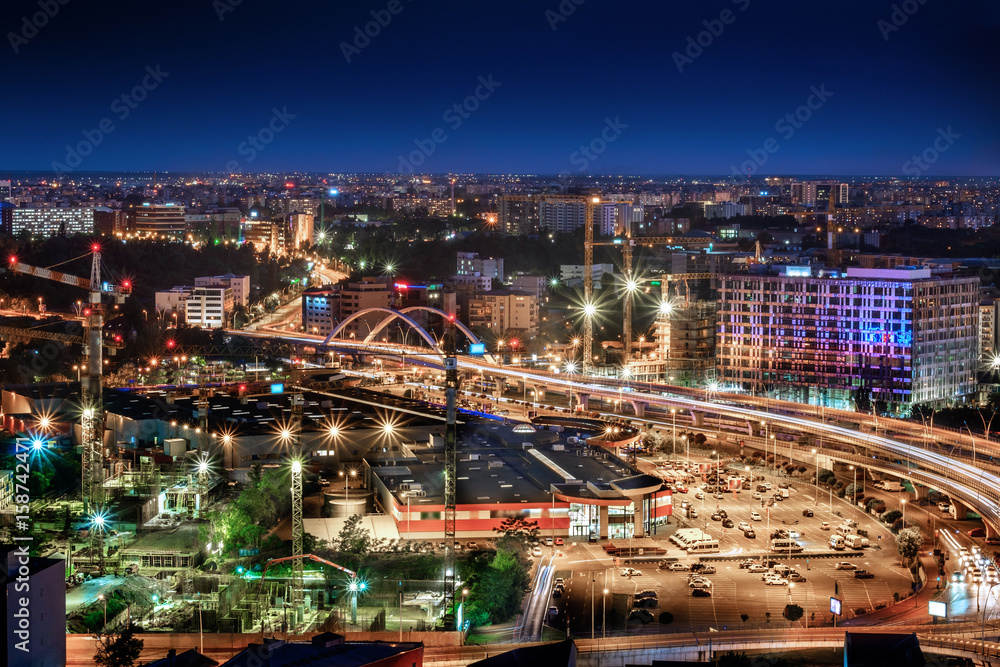Aerial wide angle view of Bucharest Basarab, Romania. Traffic and buildings at night.