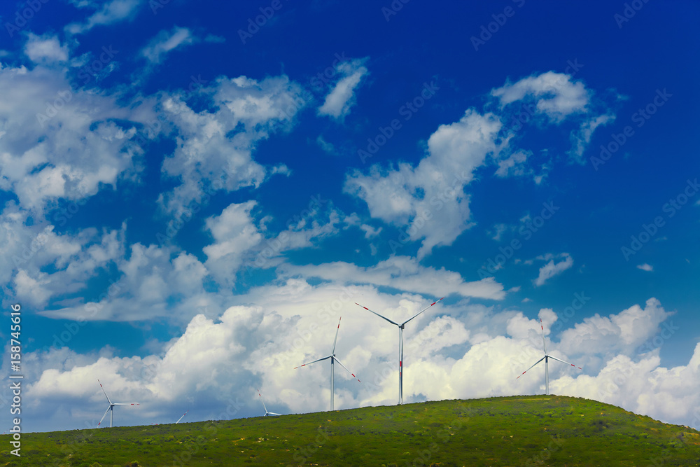 Wind mill turbines on beautiful sky background