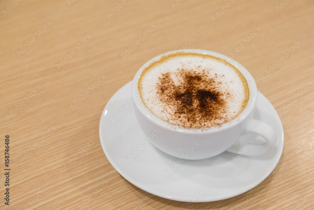 Coffee in white cup on wood table Coffee in white cup on wood table