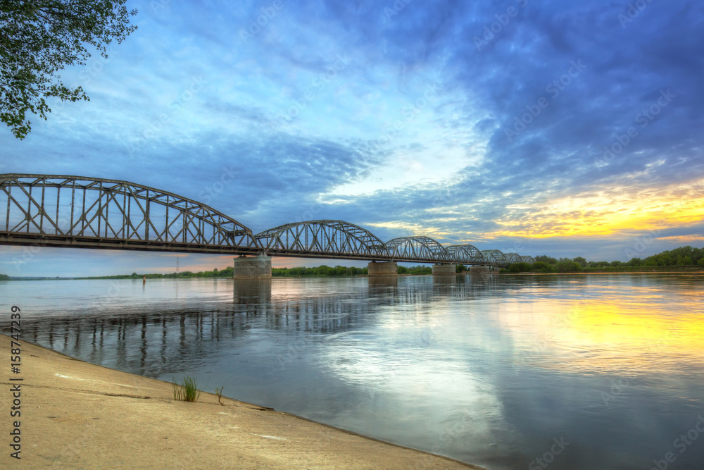 Fototapeta premium Sunset over Vistula river in Grudziadz bridge, Poland