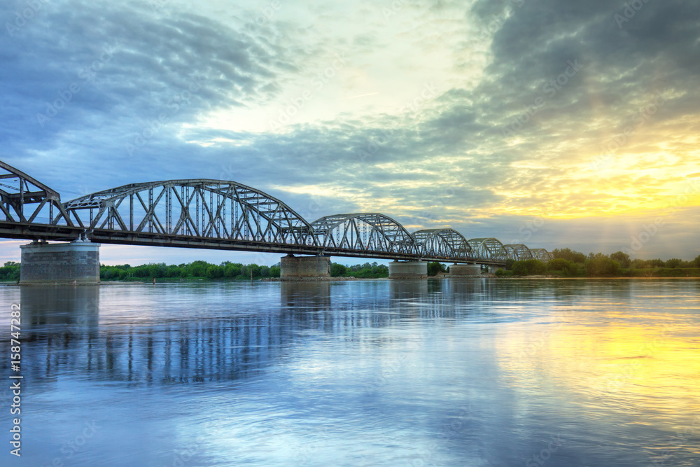 Fototapeta premium Sunset over Vistula river in Grudziadz bridge, Poland