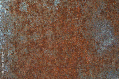 Grungy and rusty steel metal wall with heavy corrosion background texture