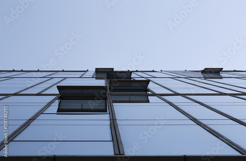 Modern office building from low perspective with blue sky background.