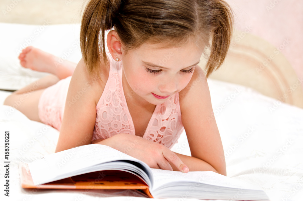 Adorable little girl child is reading a book Adorable little girl child is reading a book