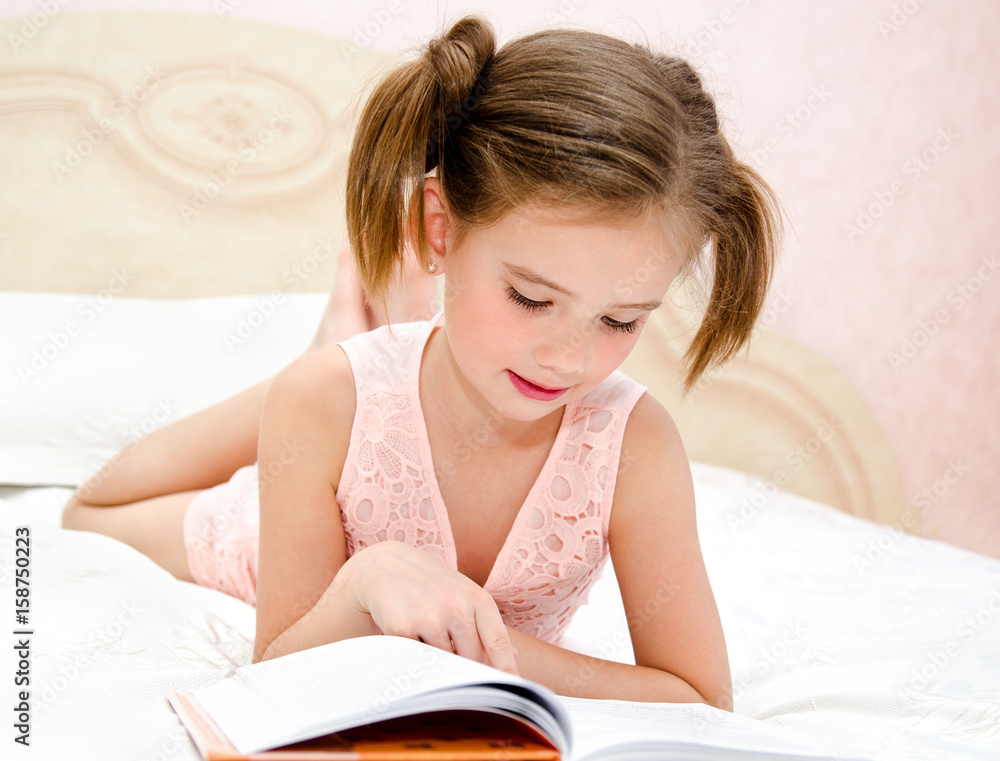 Adorable little girl child is reading a book Adorable little girl child is reading a book