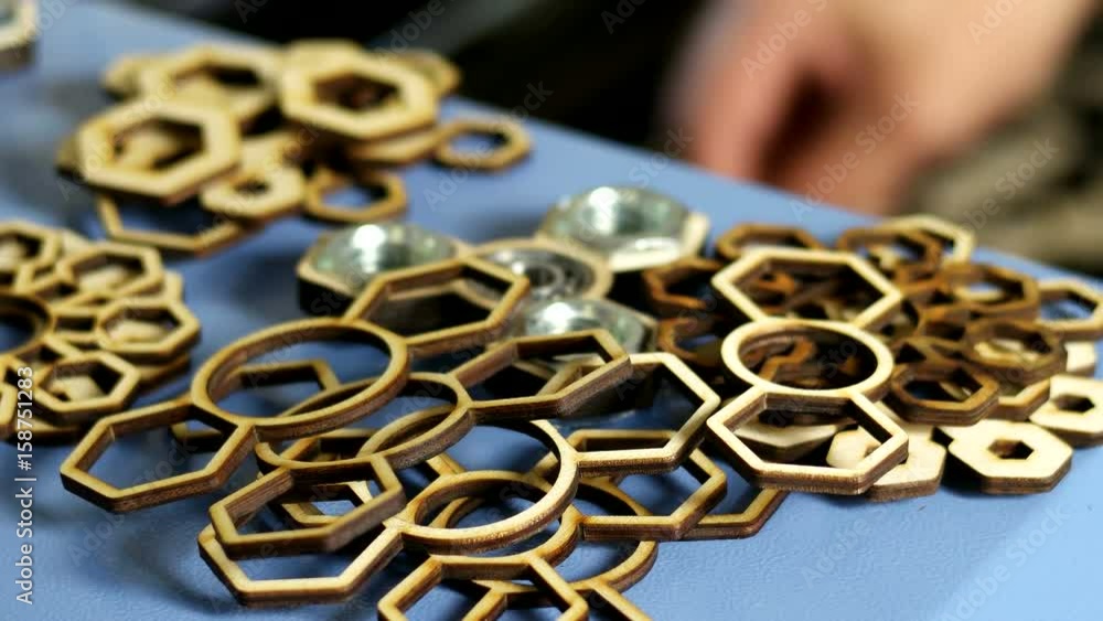 Man folds wooden parts for a hand spinner Man folds wooden parts for a hand spinner