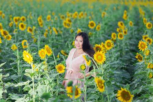 portrait Asia women in sunflower garden