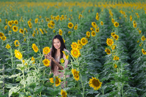 portrait Asia women in sunflower garden