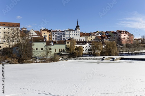 Colorful royal snowy medieval Town Pisek above the frozen river Otava, Czech Republic 