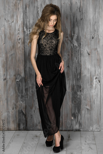 Beautiful elegant lady in a black long evening dress