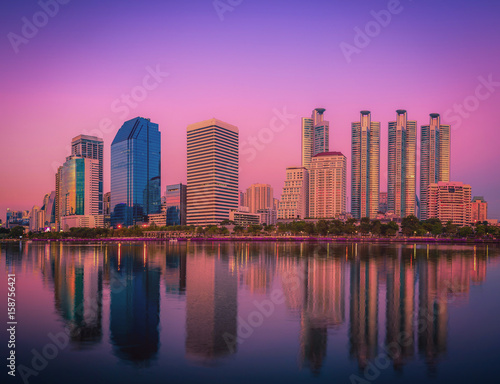 Cityscape image of Benchakitti Park at sunset in Bangkok, Thailand.