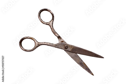 Old scissors on paper isolated on white background