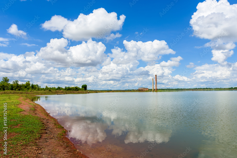Fototapeta premium Landscape of Old mill in the reservoir against blue sky