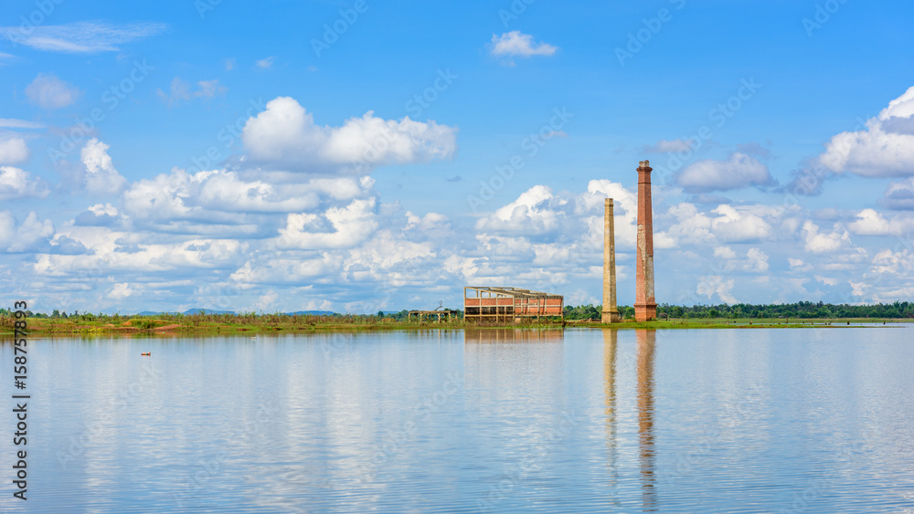 Landscape of Old mill in the reservoir against blue sky