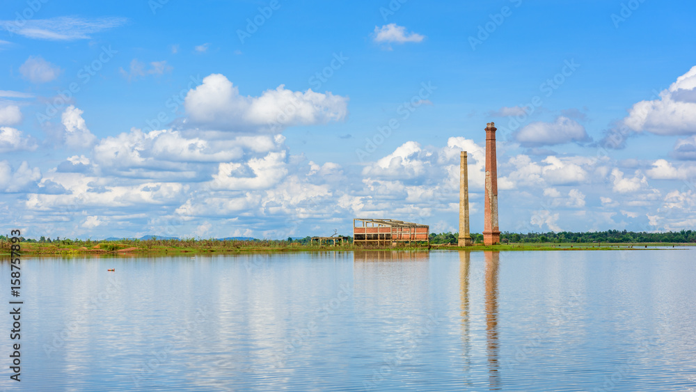 Landscape of Old mill in the reservoir against blue sky Landscape of Old mill in the reservoir against blue sky