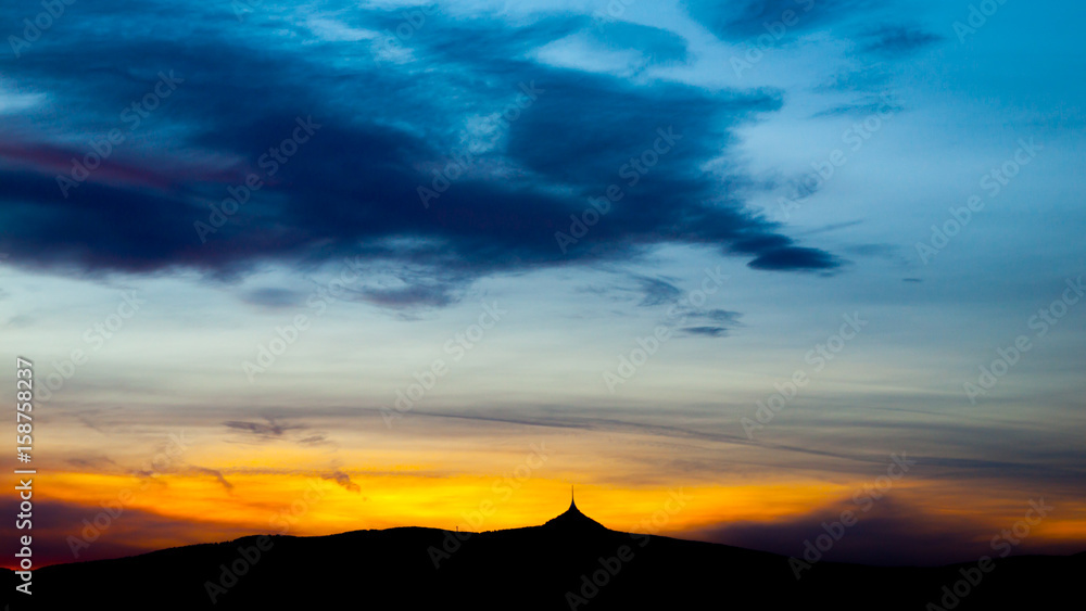 Colorful sunset sky panorama with silhouette of Jested Mountain Ridge, Liberec, Czech Republic.