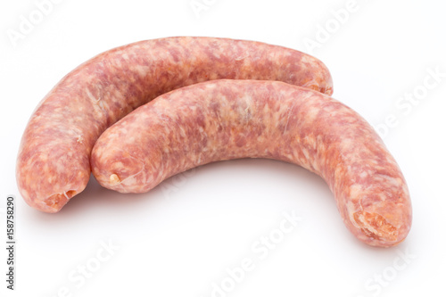 Raw sausage with parsley leaf isolated on white background.