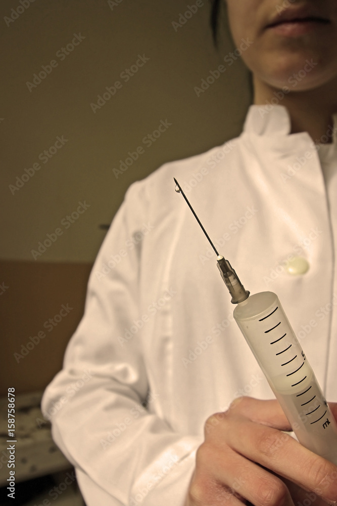 Nurse with injection in hand Nurse with injection in hand
