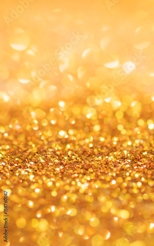 Gold light bokeh texture or glitter lights festive gold background. Christmas abstract template