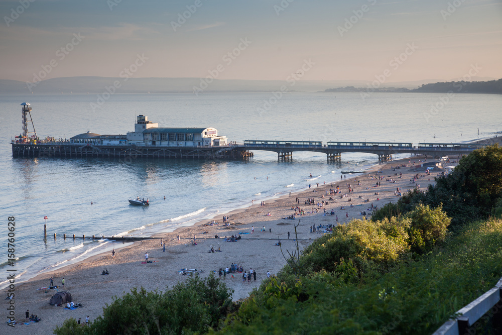 BOURNEMOUTH, UK - 1st JUNE, 2017: Bournemouth beach pier and coast, Dorset, England BOURNEMOUTH, UK - 1st JUNE, 2017: Bournemouth beach pier and coast, Dorset, England