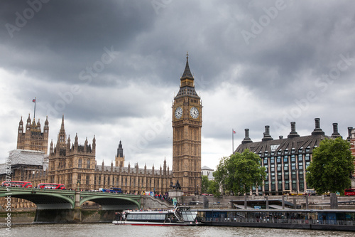 LONDON/UK - MAY 20 : Unidentified tourists travel on a sightseeing boat along the Thames, Big Ben and Westminster Bridge in the background