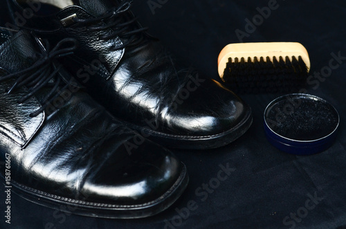 Businessman cleaning shoes