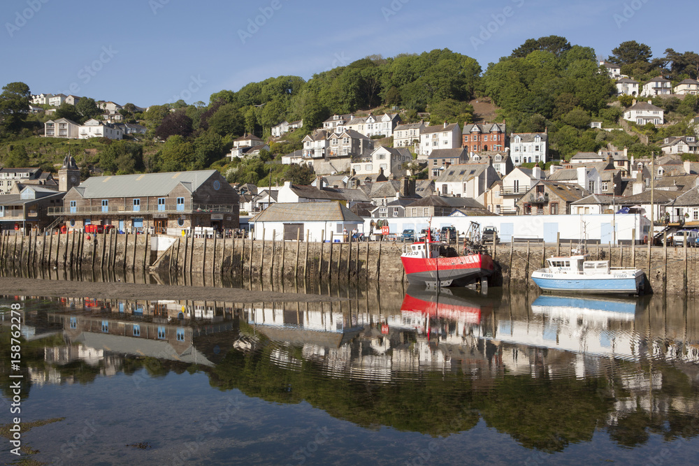 Low tide at Looe Cornwall with fishing boats moored at the fish quay on the East Looe river Low tide at Looe Cornwall with fishing boats moored at the fish quay on the East Looe river