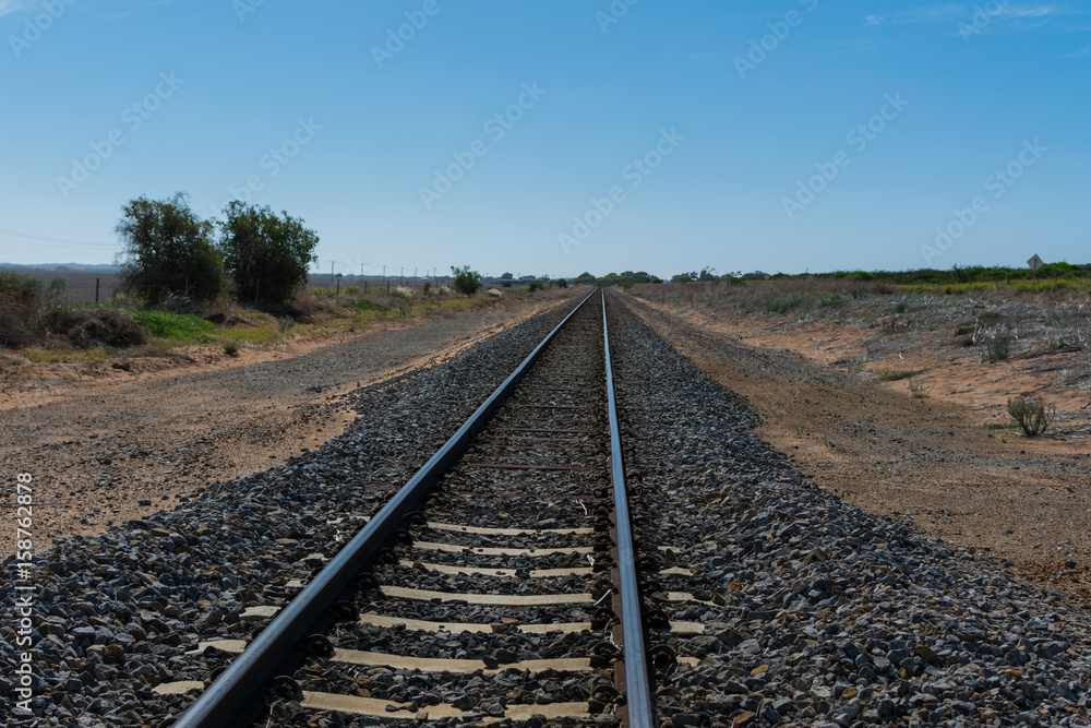 Fototapeta premium Train tracks passing through farming country