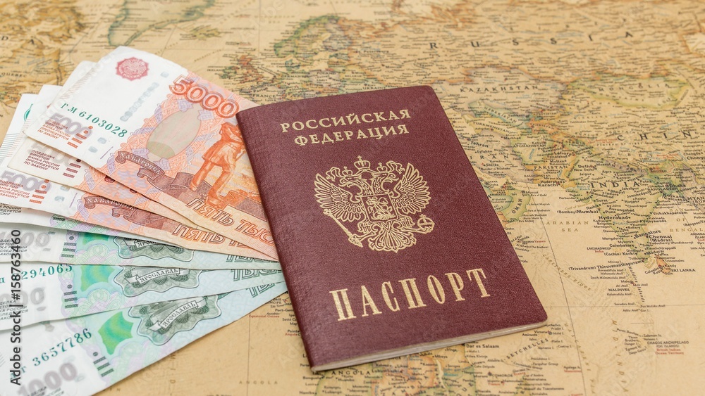 Russian passport with money within on the world map