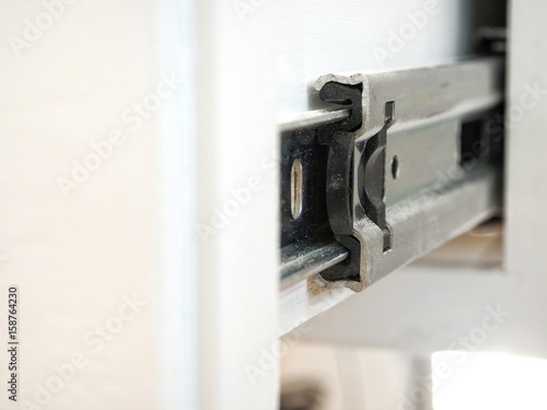 Furniture slide rail or metal drawer track, closeup