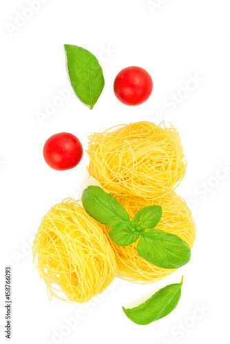 Angel Hair pasta preparation for cooking by angel hair pasta, tomatoes, basil leaves all ingredients are organics isolated on white background