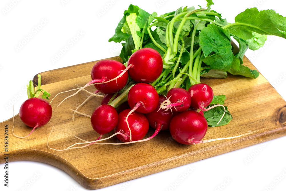 Washed red young radish on wooden board Washed red young radish on wooden board