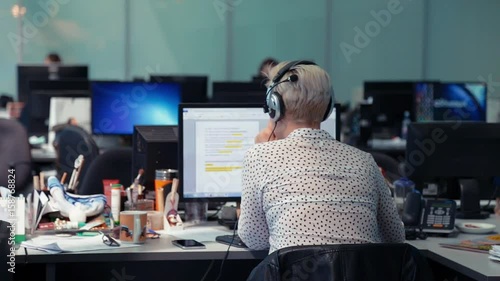 A journalist working on a computer in Newsroom