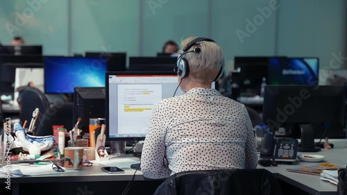 A journalist working on a computer in Newsroom