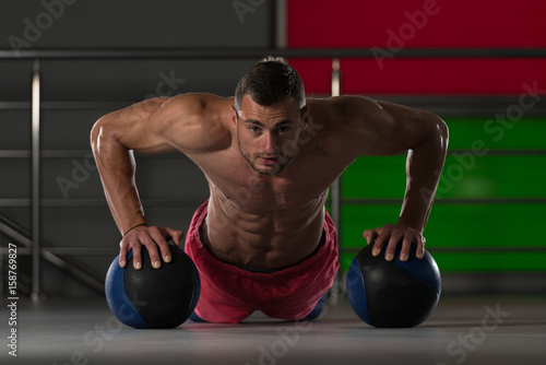 Personal Trainer Doing Push-ups With Ball