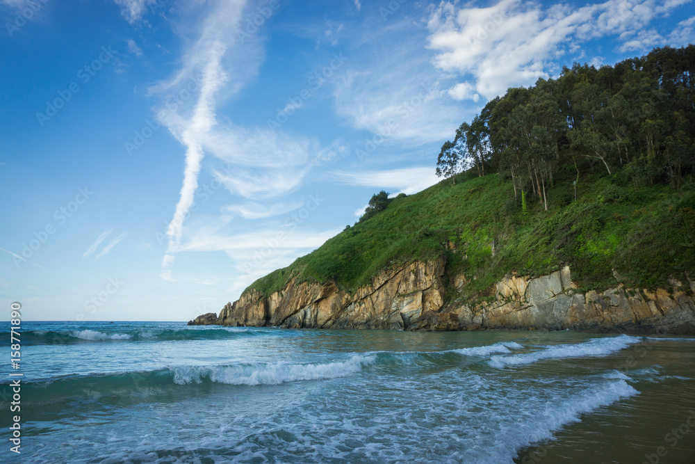 Beautiful beach in the north of Spain, nature of Asturias in warm summer day