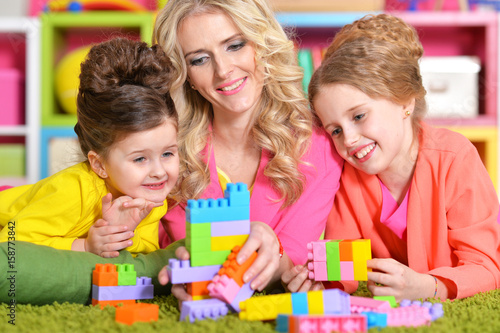 young woman playing with daughters