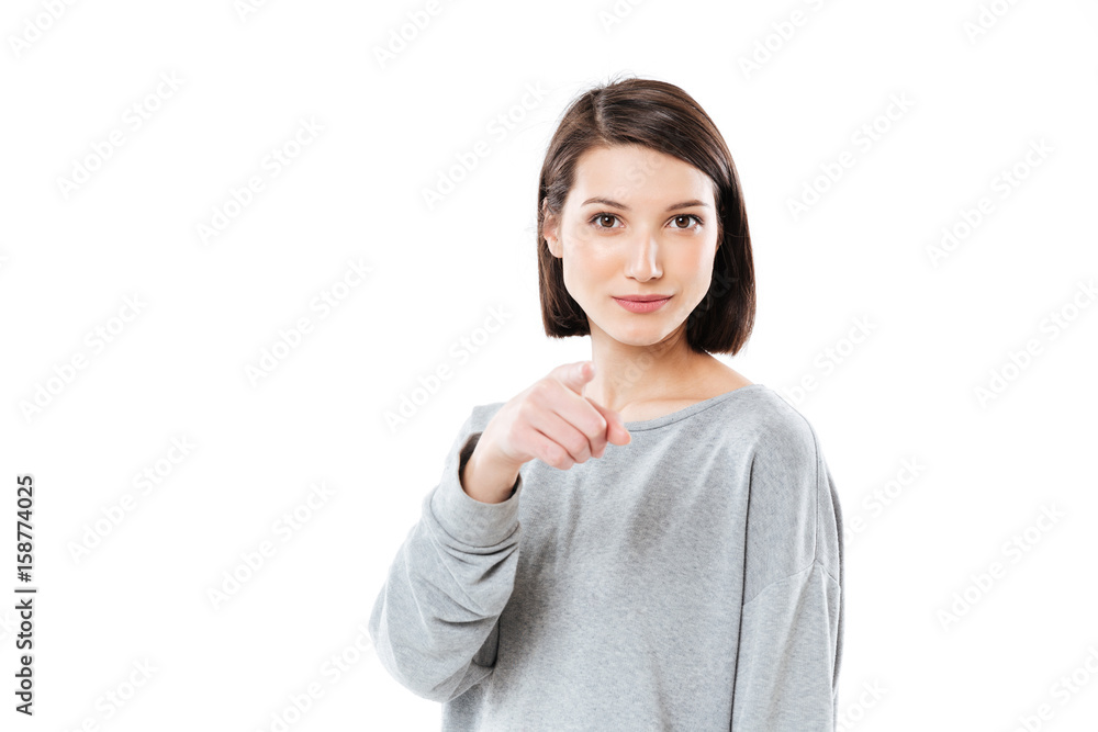Portrait of a pretty young woman pointing finger at camera Portrait of a pretty young woman pointing finger at camera