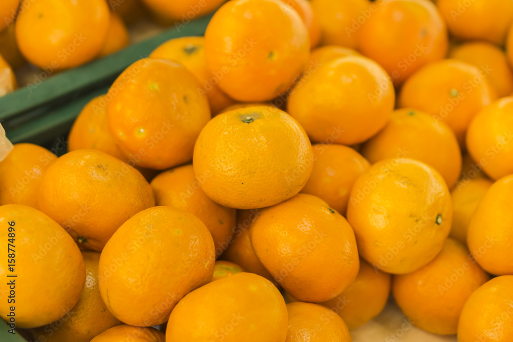 oranges fruit on market stall,with chinese new year background, in market,selective focus. oranges fruit on market stall,with chinese new year background, in market,selective focus.
