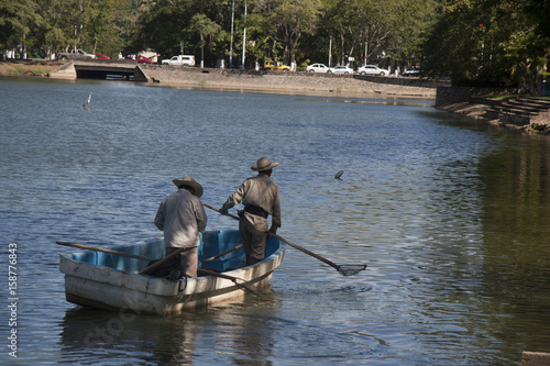 Two man on boat. Lagoon of illusions, Tomas Garrido Canabal Park, Villahermosa, Tabasco, Mexico. photo